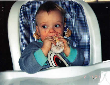Picture of Kaleb Tilton eating donut.
